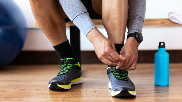 man-tying-shoes-gym